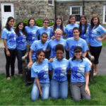 women posing in matching shirts outdoors