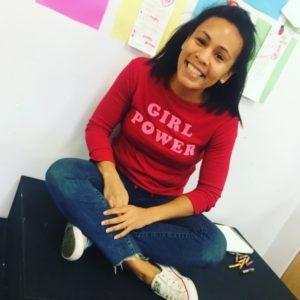 woman smiling wearing girl power shirt